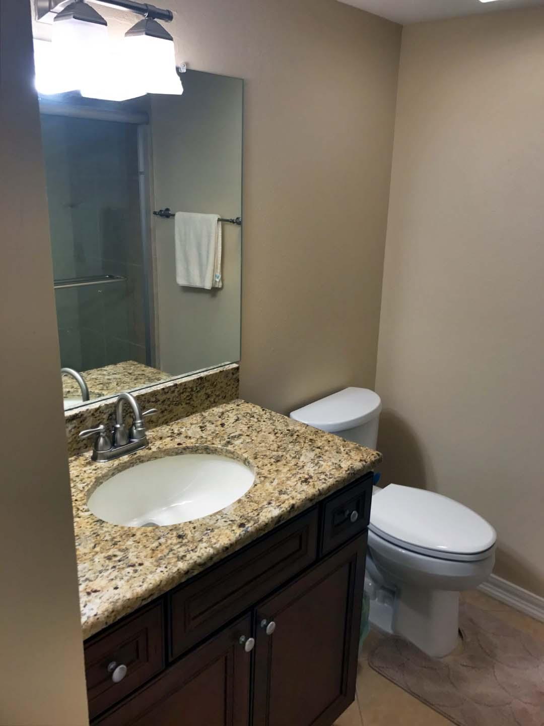 5073 Beachwalk Way Miramar Beach, FL 32550 - Photo 32 of 61 a bathroom with a granite countertop sink and a mirror