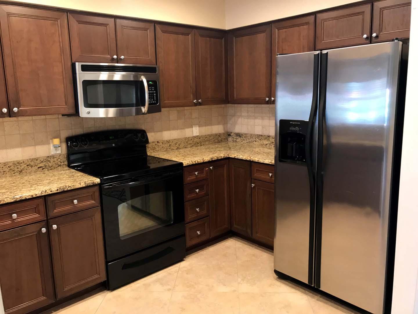 5073 Beachwalk Way Miramar Beach, FL 32550 - Photo 9 of 61 a kitchen with granite countertop a cabinets and steel stainless steel appliances with cabinets