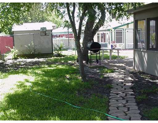 4217 Nicklaus Lane Corpus Christi, TX 78413 - Photo 6 of 7 a backyard of a house with yard and outdoor seating