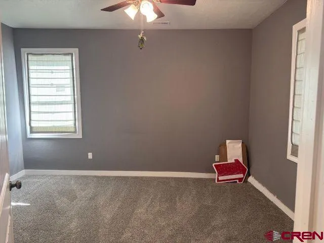 a room with a window and a fan