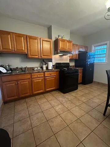 a kitchen with stainless steel appliances granite countertop a stove a sink dishwasher and a refrigerator