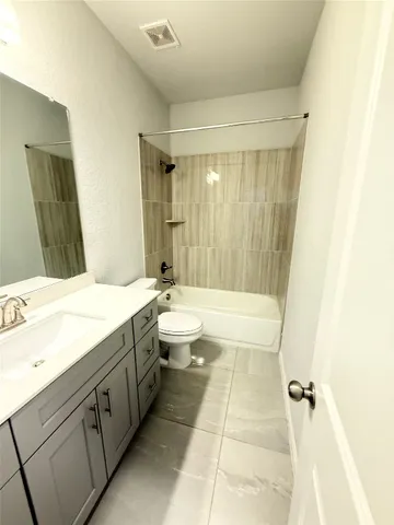 a bathroom with a double vanity sink toilet mirror and bathtub