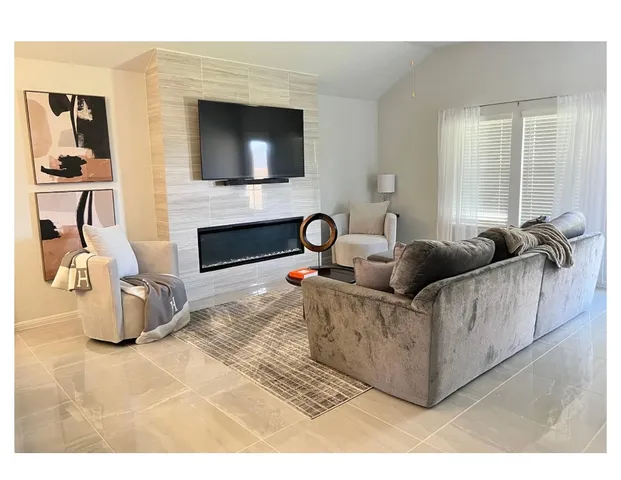 a large white kitchen with a stove a sink dishwasher and a refrigerator with wooden floor