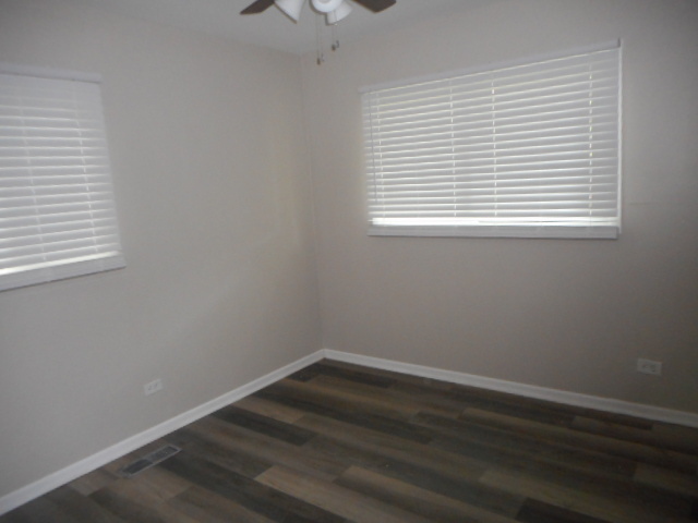 1860 Ashley Road Hoffman Estates, IL 60169 - Photo 13 of 27 an empty room with wooden floor and windows