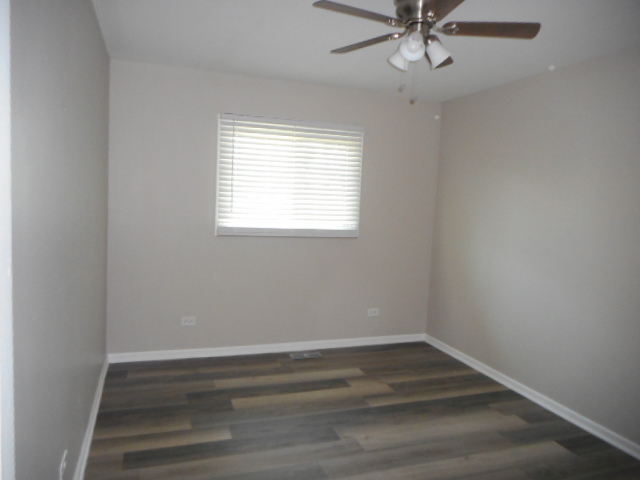 1860 Ashley Road Hoffman Estates, IL 60169 - Photo 17 of 27 wooden floor in an empty room with a window