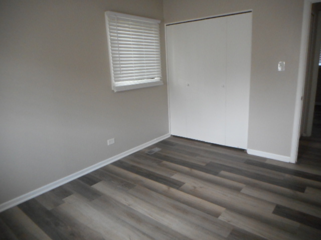 1860 Ashley Road Hoffman Estates, IL 60169 - Photo 18 of 27 a view of an empty room with wooden floor and a window