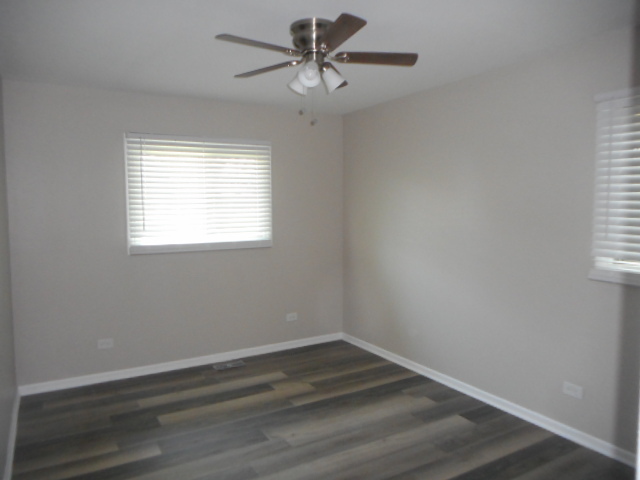 1860 Ashley Road Hoffman Estates, IL 60169 - Photo 20 of 27 wooden floor in an empty room with a window