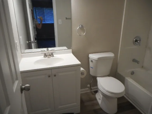 a bathroom with a sink mirror vanity and toilet