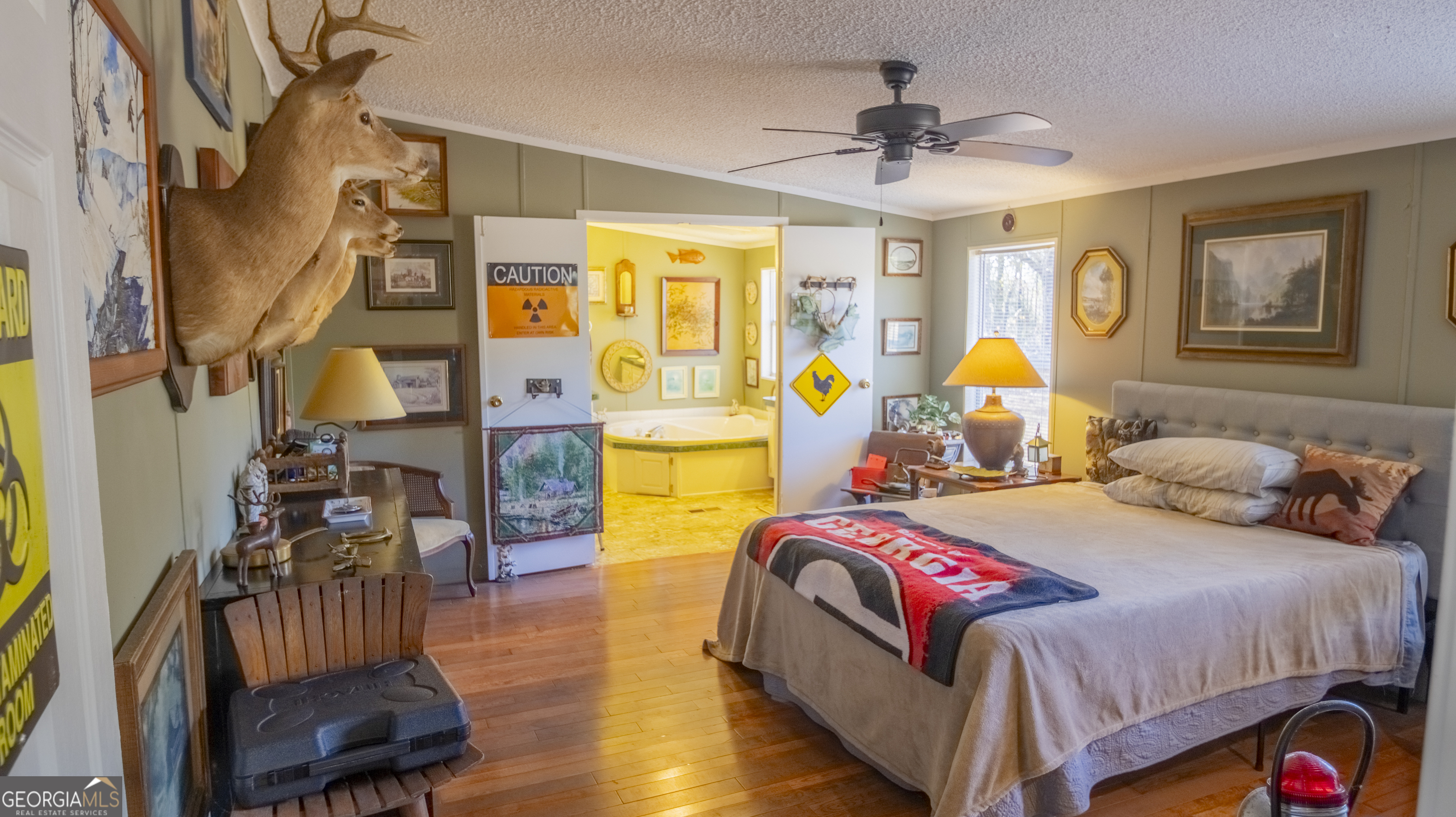 2717 Mount Pilgrim Road Greenville, GA 30222 - Photo 21 of 65 a bedroom with a bed and a chandelier