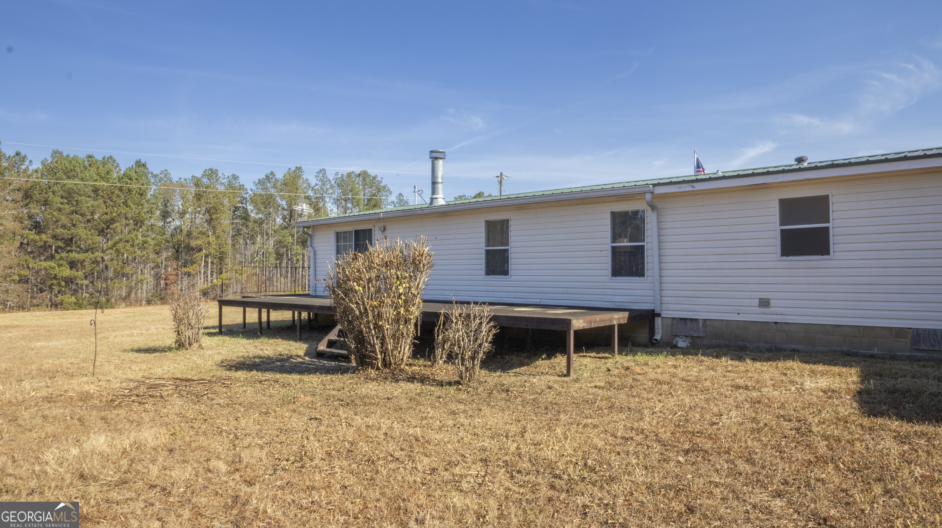 2717 Mount Pilgrim Road Greenville, GA 30222 - Photo 39 of 65 a view of a house with backyard and sitting area