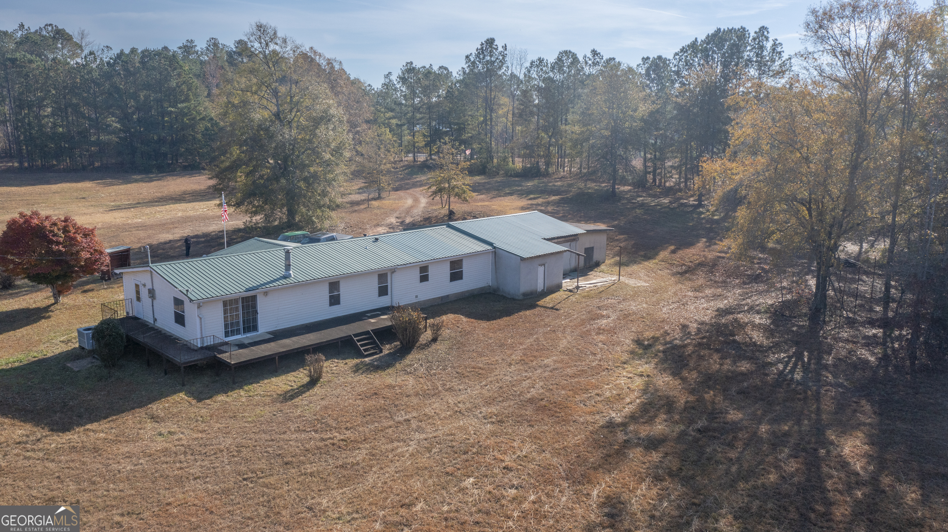 2717 Mount Pilgrim Road Greenville, GA 30222 - Photo 46 of 65 a view of a small house with a yard covered in snow