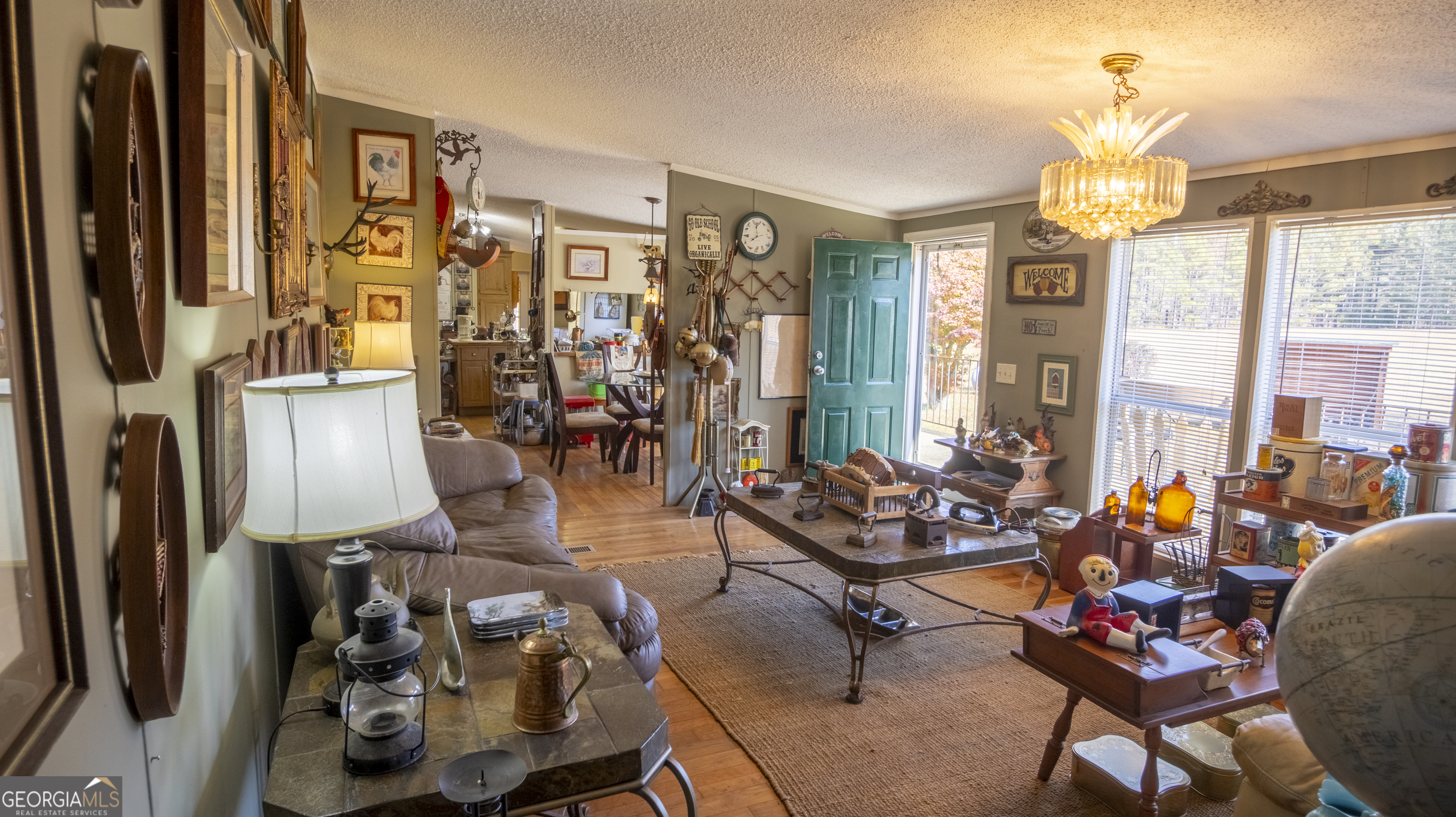 2717 Mount Pilgrim Road Greenville, GA 30222 - Photo 5 of 65 a living room with lots of furniture and a chandelier