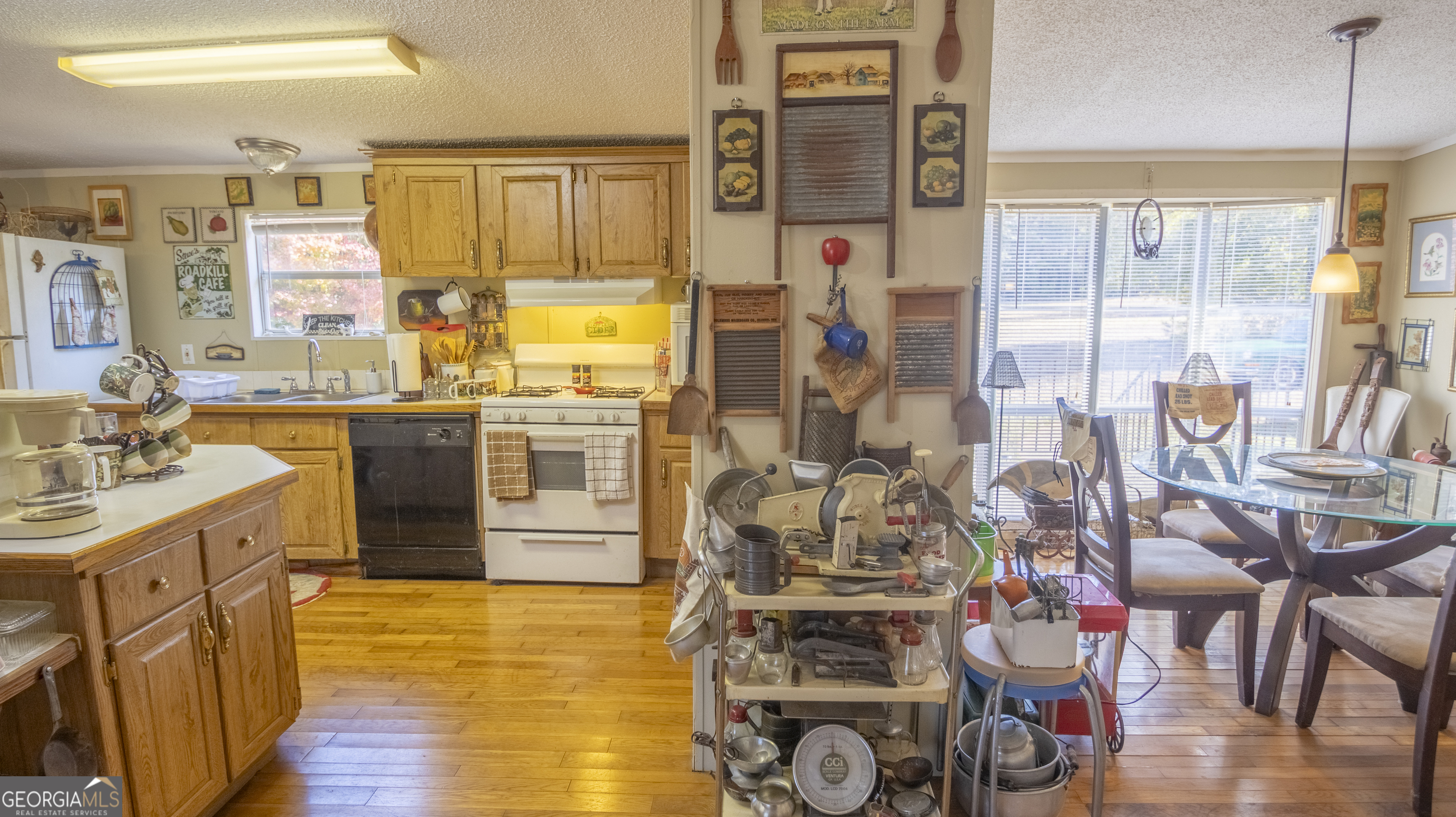 2717 Mount Pilgrim Road Greenville, GA 30222 - Photo 9 of 65 a kitchen with stainless steel appliances granite countertop a stove and cabinets with wooden floor