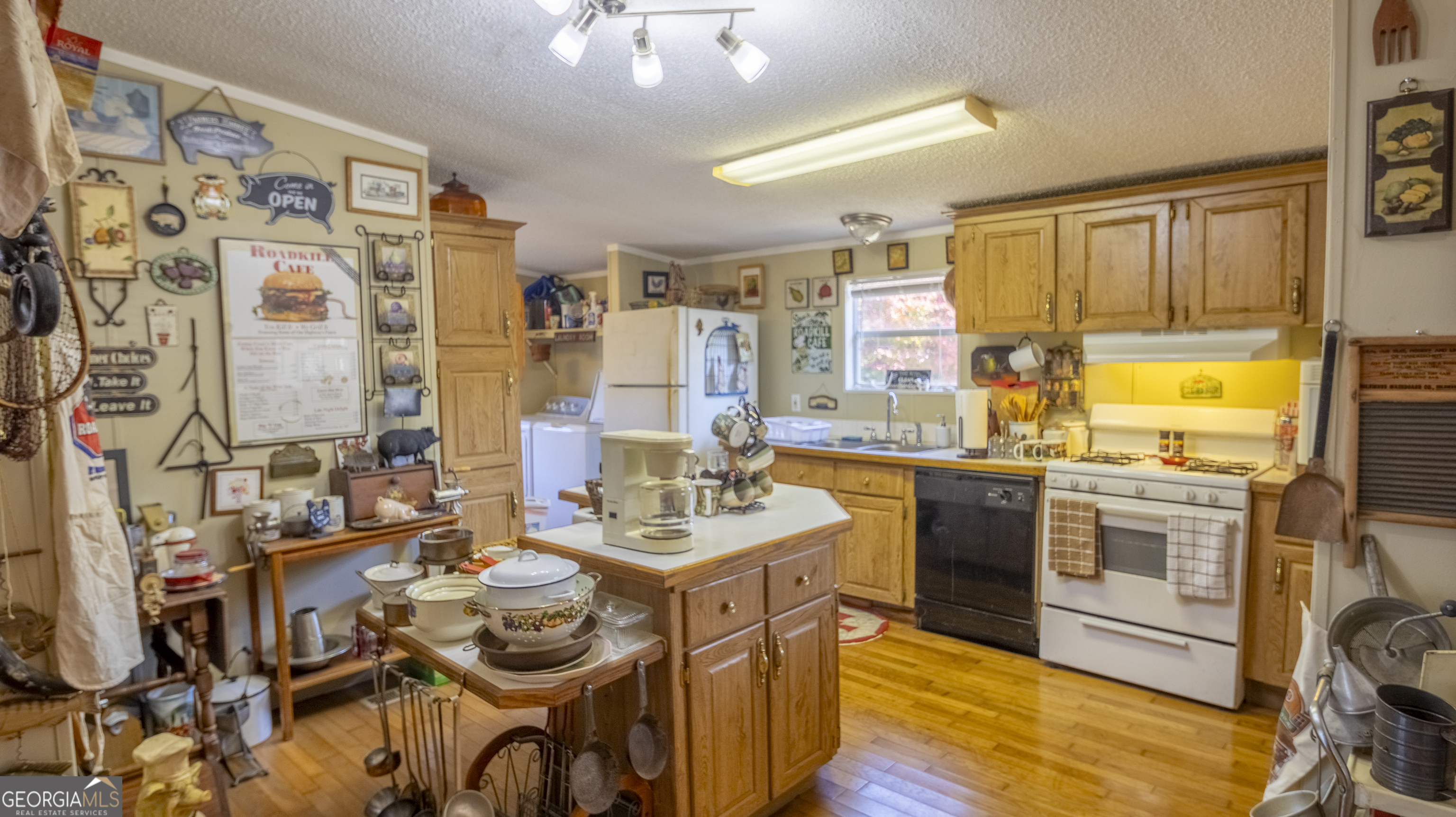 2717 Mount Pilgrim Road Greenville, GA 30222 - Photo 10 of 65 a kitchen with stainless steel appliances kitchen island granite countertop a sink and cabinets