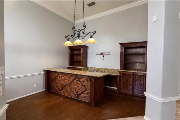 a view of a kitchen with a stove and a chandelier