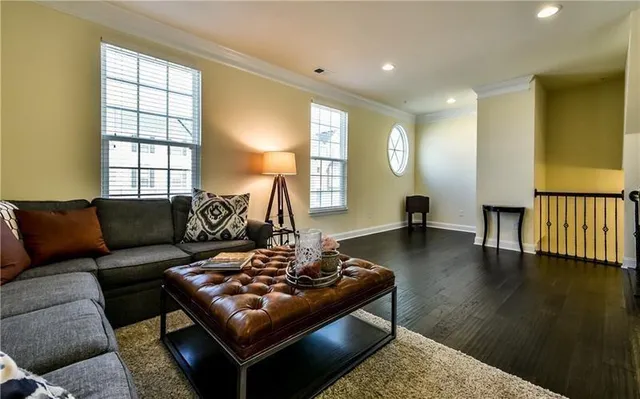 a living room with furniture and wooden floor
