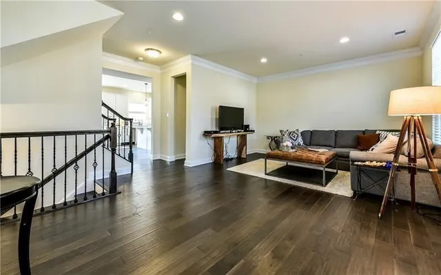 a living room with furniture flat screen tv and wooden floor