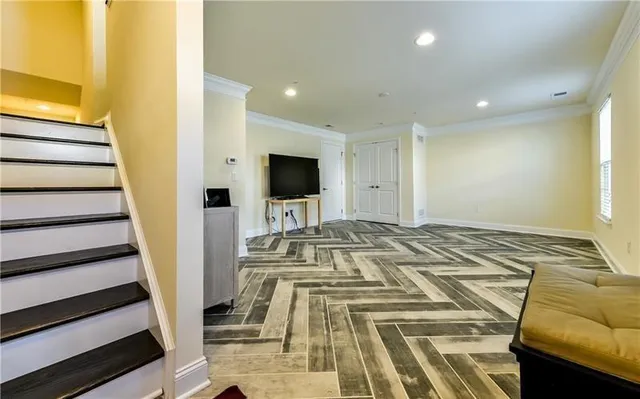 a view of a bedroom with wooden floor and staircase