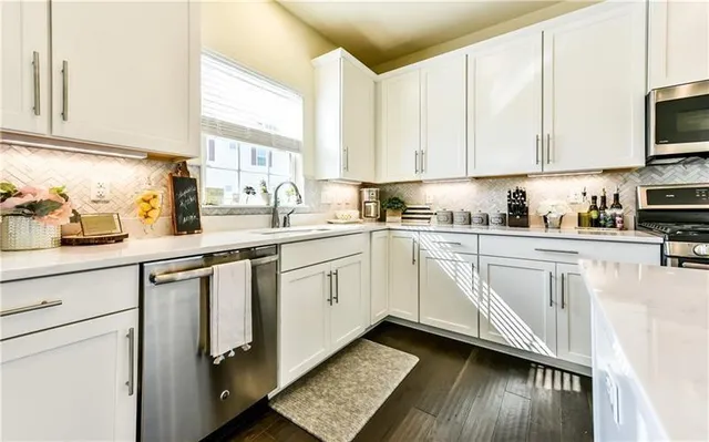 a kitchen with appliances cabinets and a sink