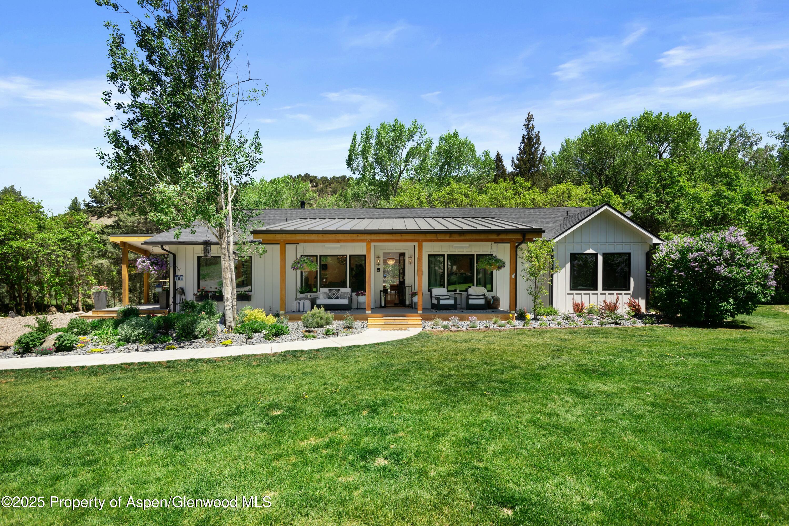 a front view of a house with swimming pool having outdoor seating