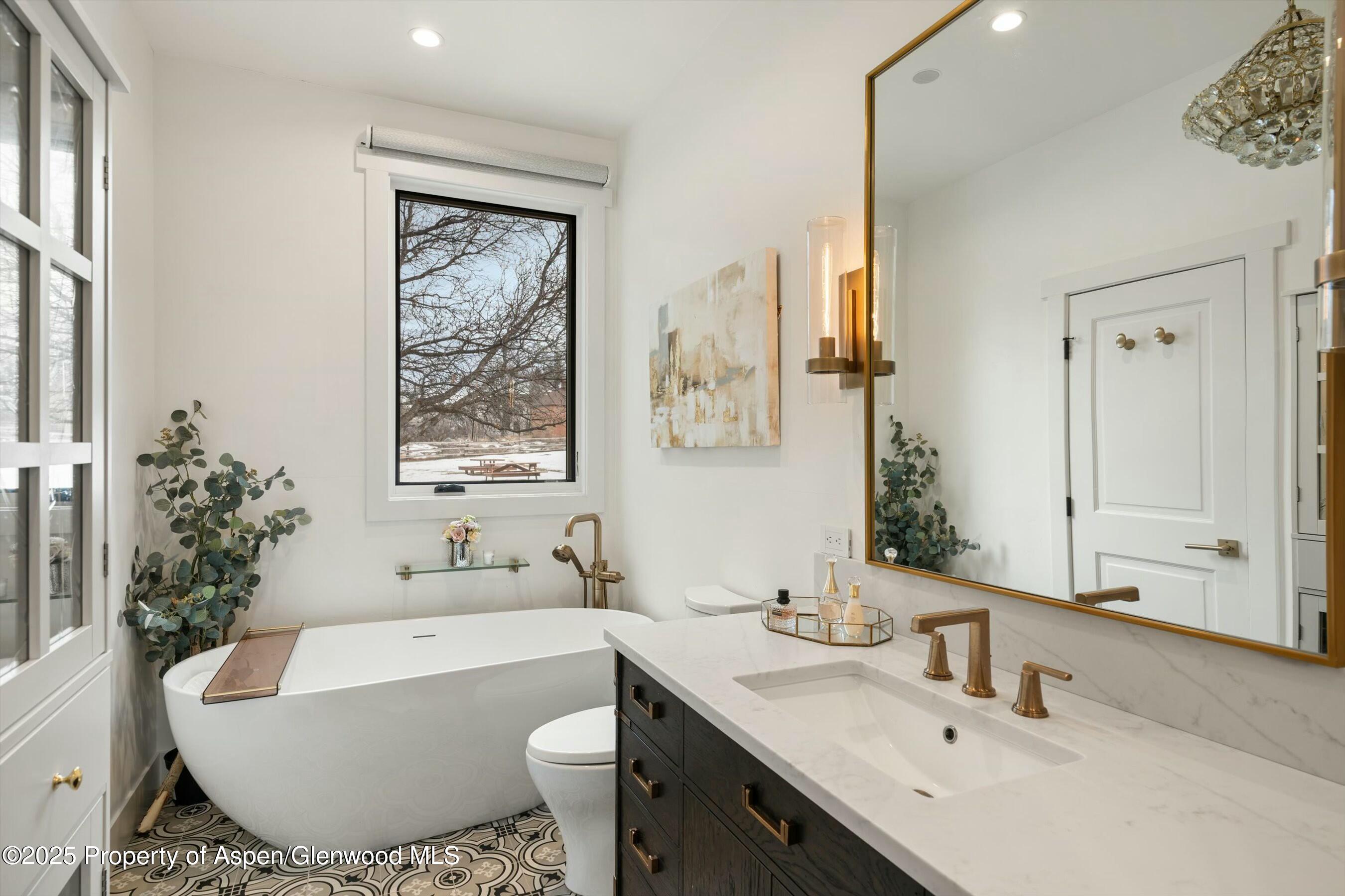 1631 Emma Spur Basalt, CO 81621 - Photo 24 of 52 a bathroom with a bathtub sink and mirror