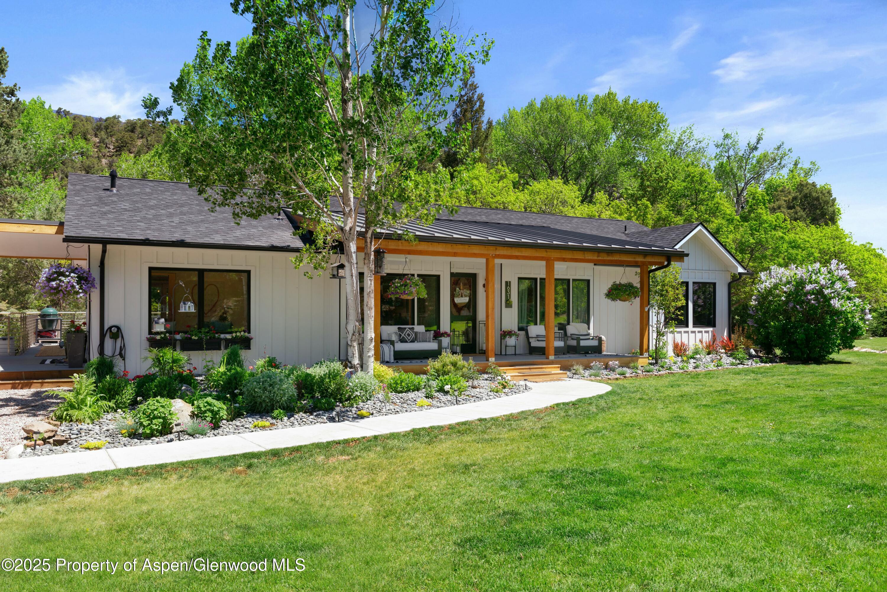 1631 Emma Spur Basalt, CO 81621 - Photo 3 of 52 a front view of house with a garden and patio
