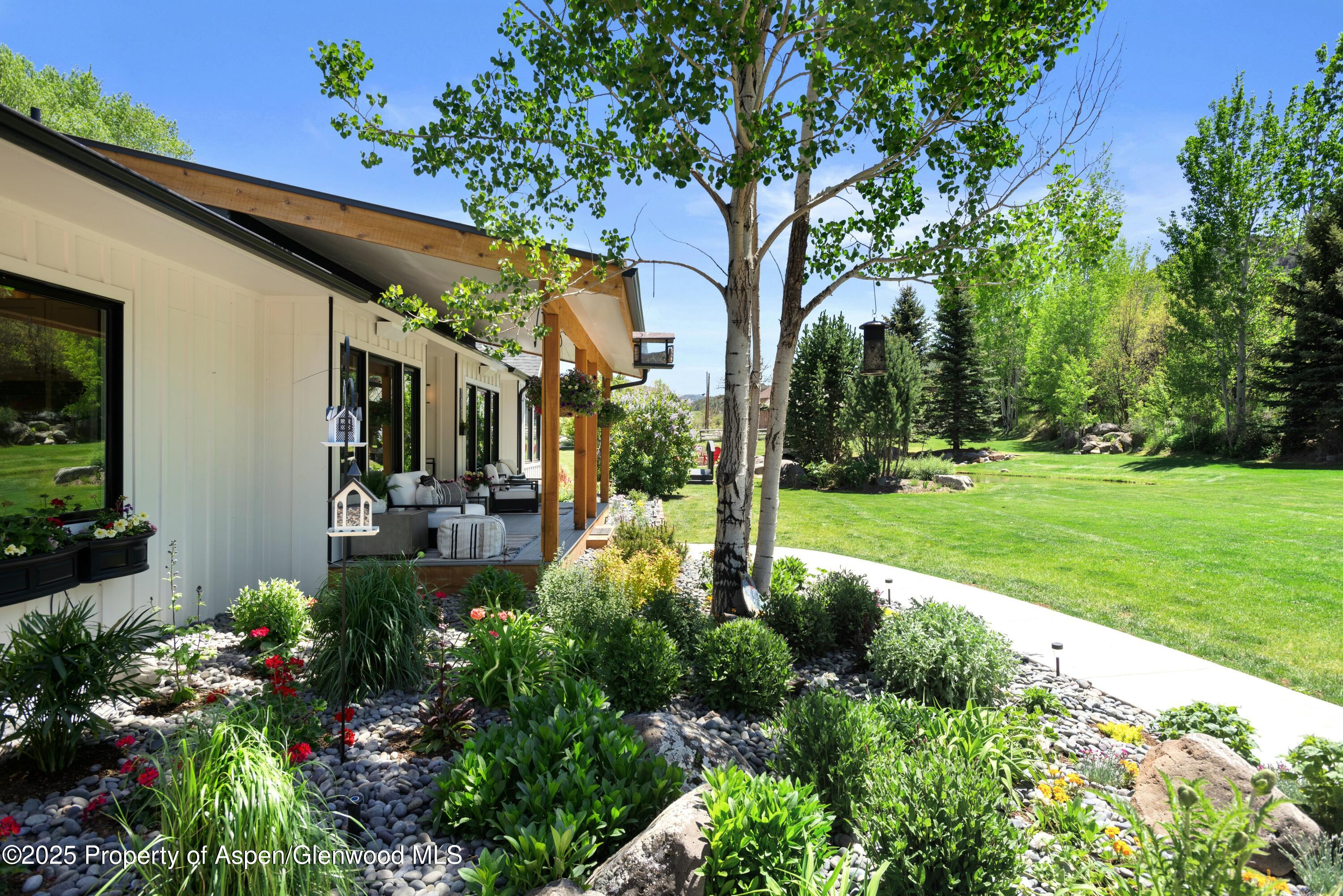 1631 Emma Spur Basalt, CO 81621 - Photo 4 of 52 a view of a patio with couches table and chairs and potted plants