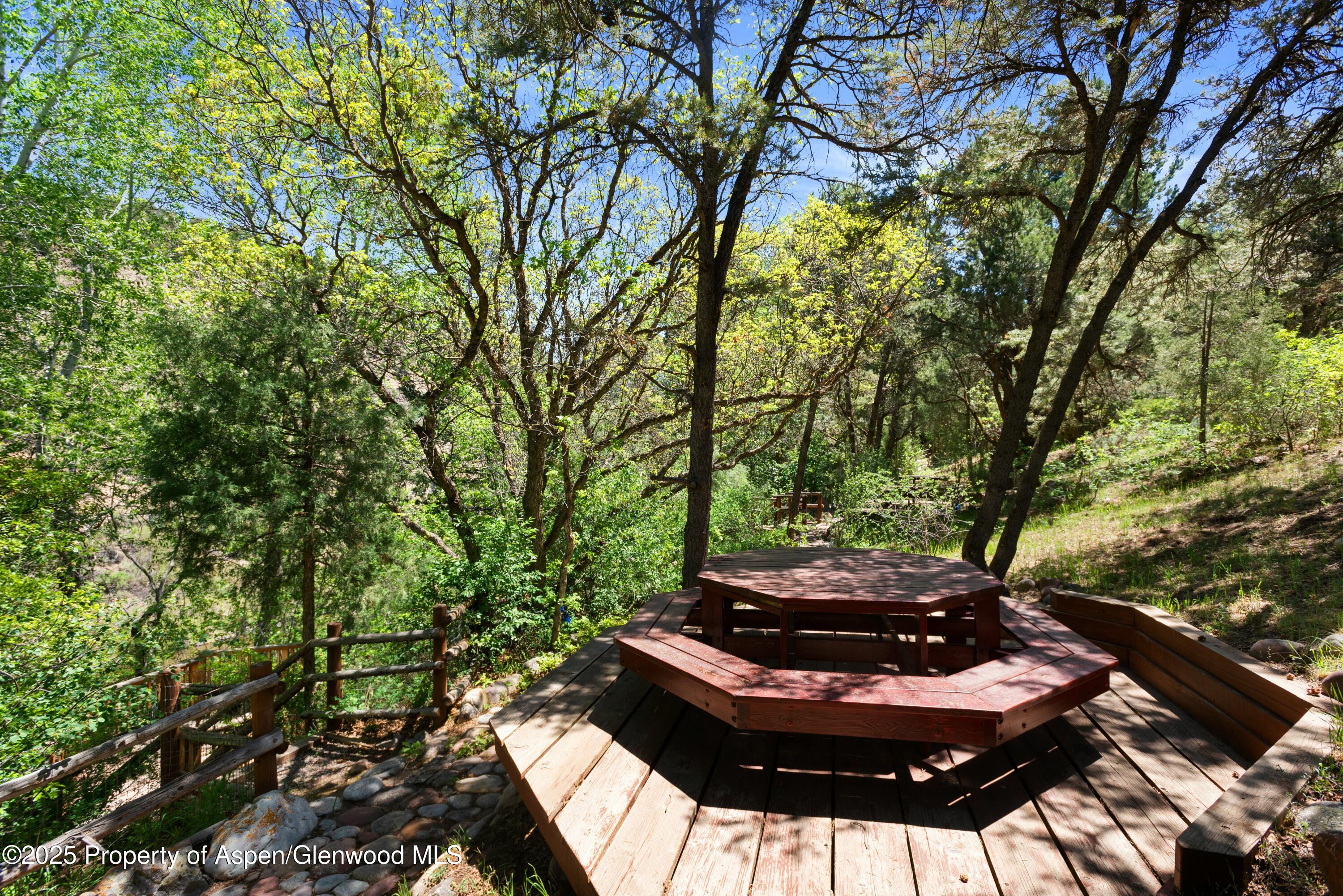 1631 Emma Spur Basalt, CO 81621 - Photo 50 of 52 a view of a backyard with table and chairs and a fire pit