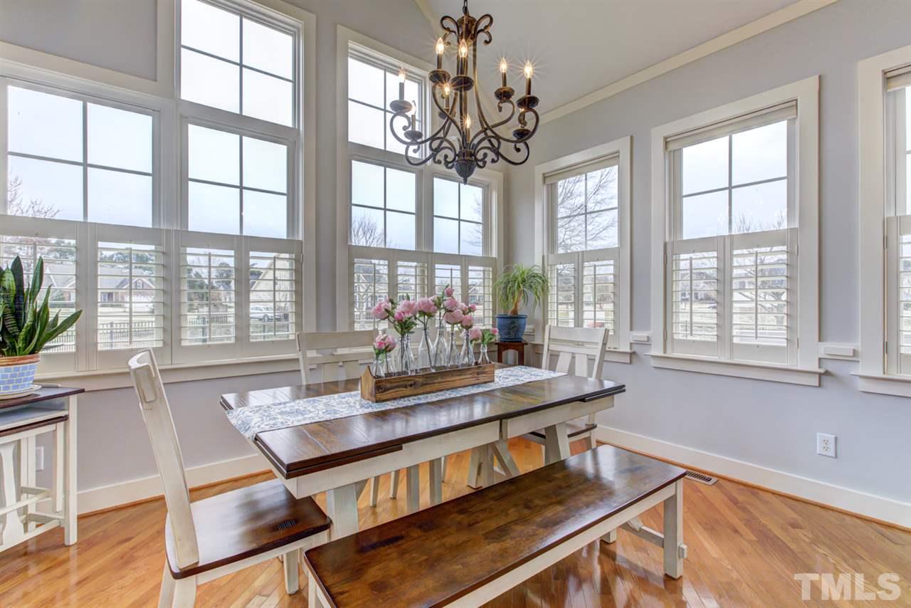 4609 Swordfish Drive Raleigh, NC 27603 - Photo 11 of 30 a view of a dining room with furniture a chandelier and wooden floor