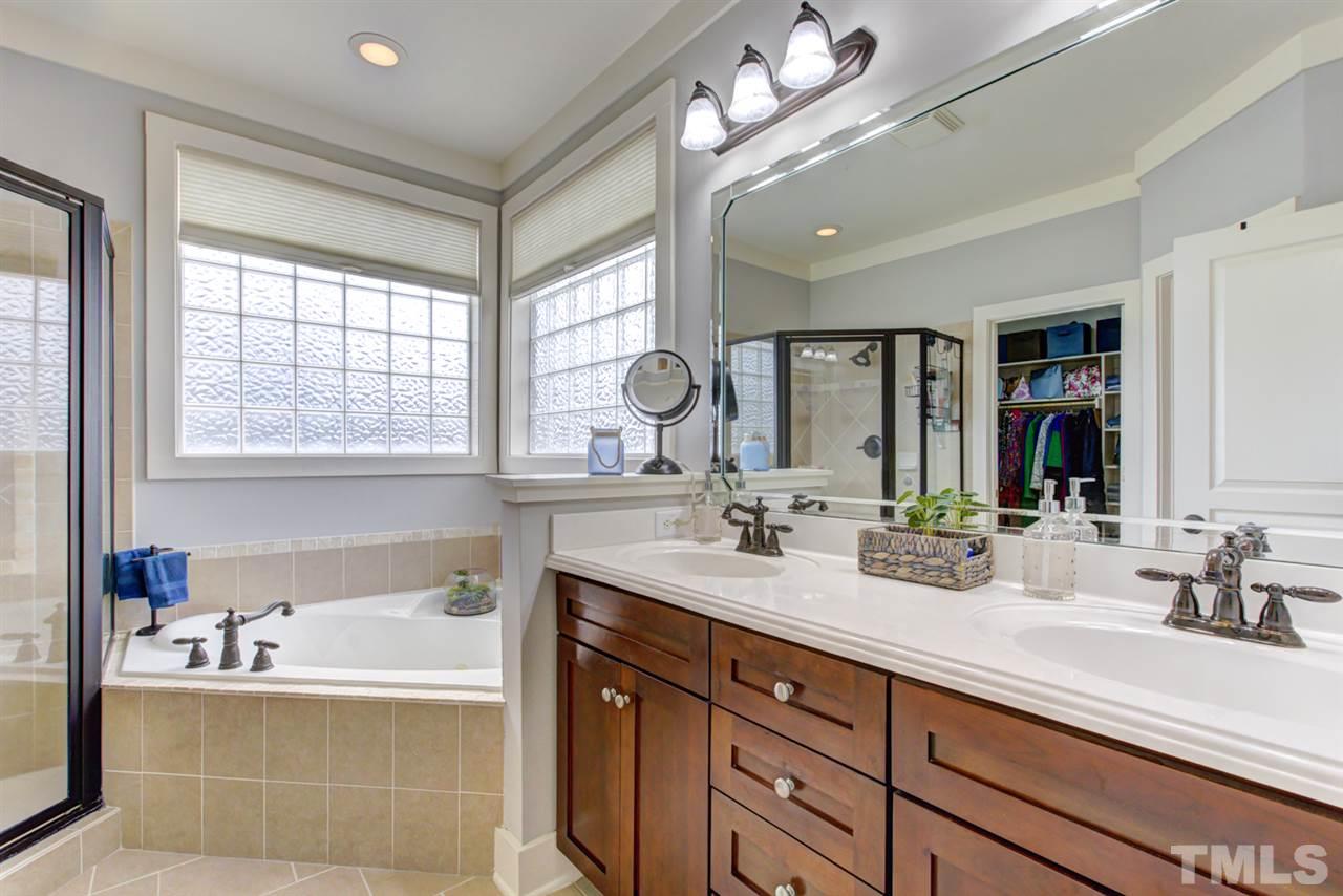 4609 Swordfish Drive Raleigh, NC 27603 - Photo 14 of 30 a bathroom with a sink double vanity and a mirror
