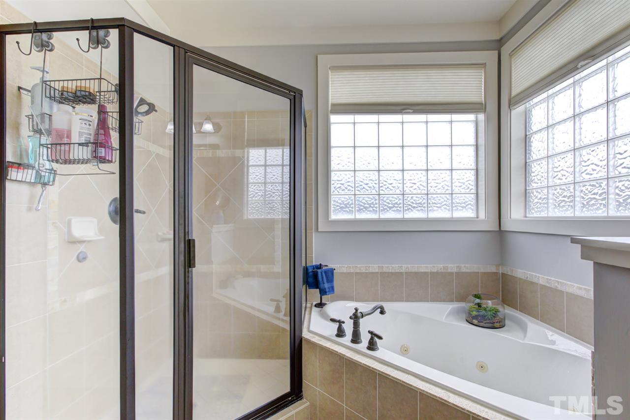 4609 Swordfish Drive Raleigh, NC 27603 - Photo 15 of 30 a bathroom with a bathtub and a shower
