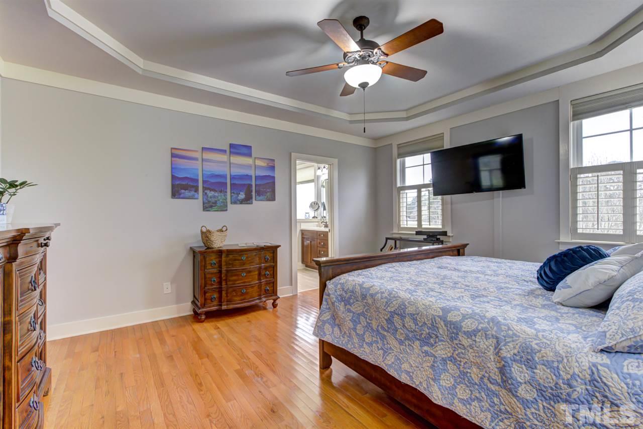 4609 Swordfish Drive Raleigh, NC 27603 - Photo 16 of 30 a bedroom with a bed and a flat screen tv