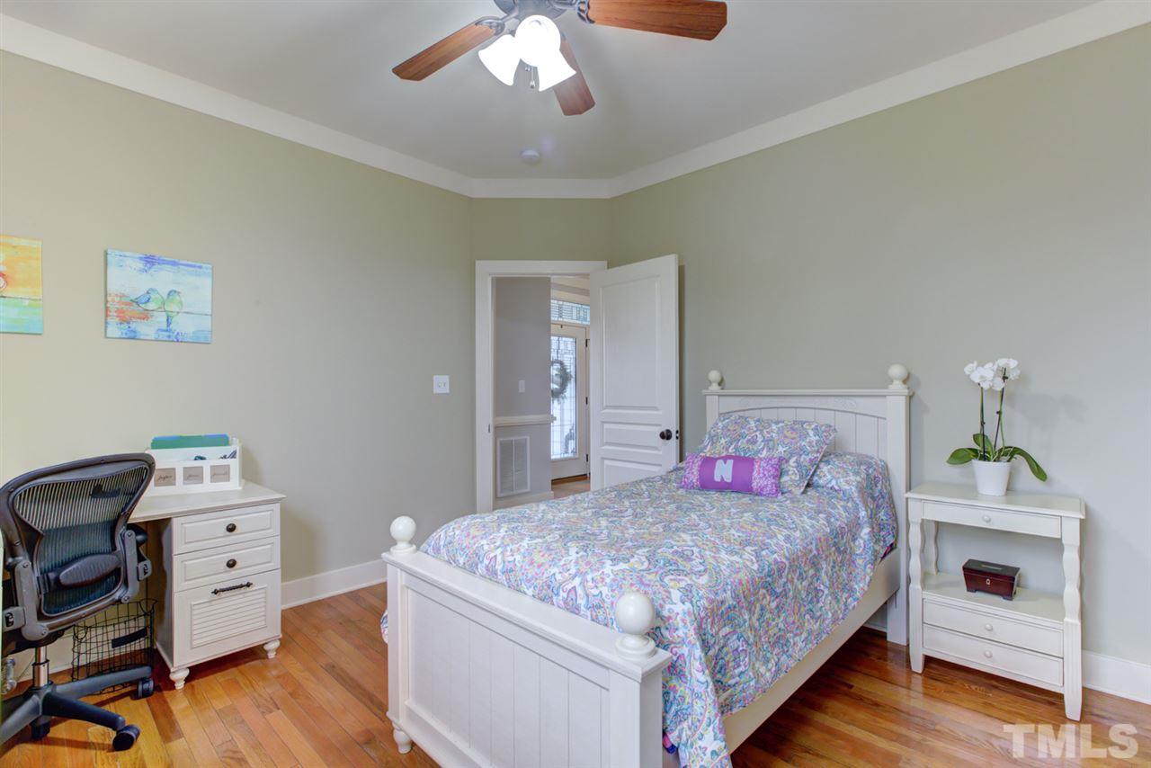 4609 Swordfish Drive Raleigh, NC 27603 - Photo 17 of 30 a bedroom with a bed and wooden floor