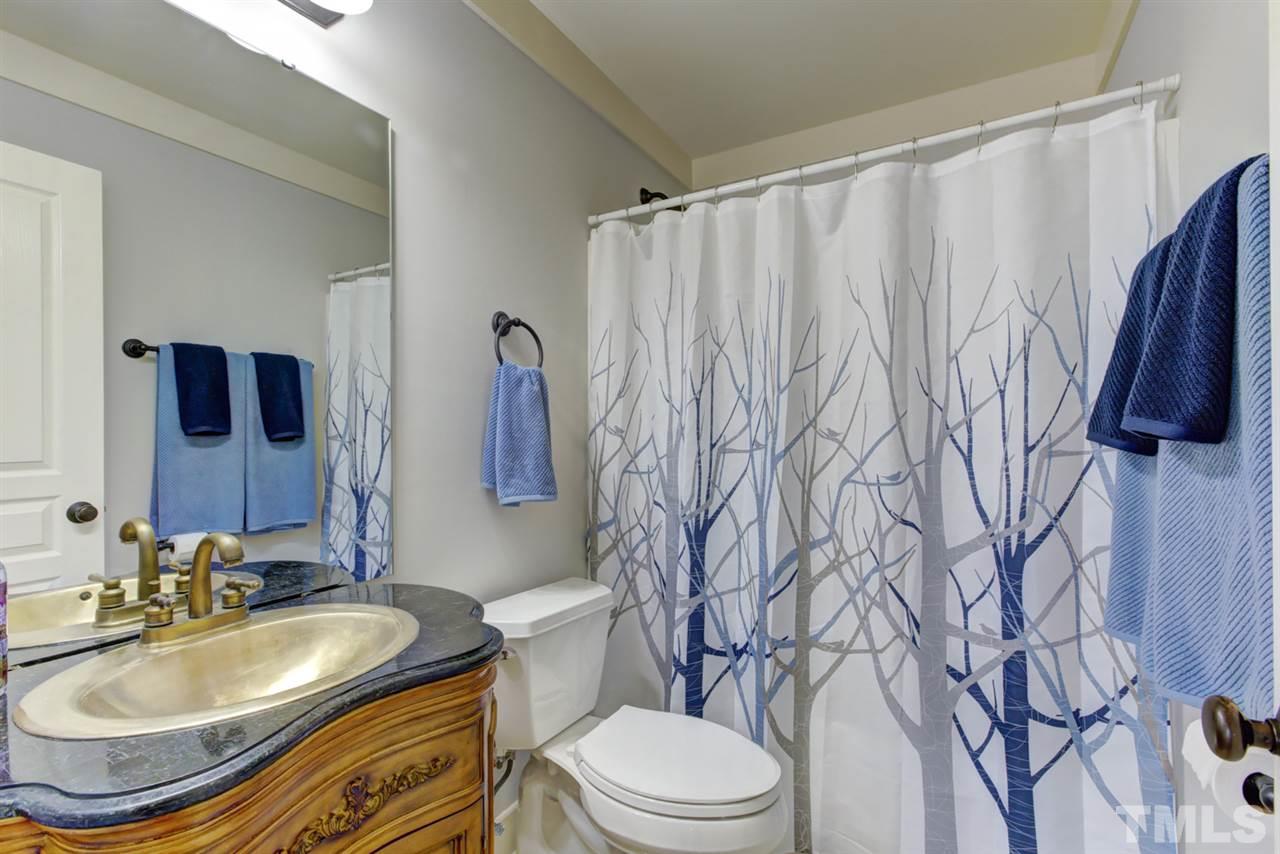 4609 Swordfish Drive Raleigh, NC 27603 - Photo 20 of 30 a bathroom with a sink toilet and shower