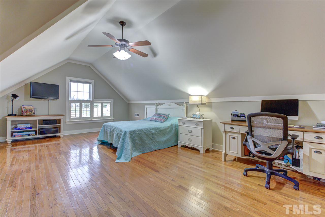 4609 Swordfish Drive Raleigh, NC 27603 - Photo 21 of 30 a bedroom with a bed ceiling fan and a window