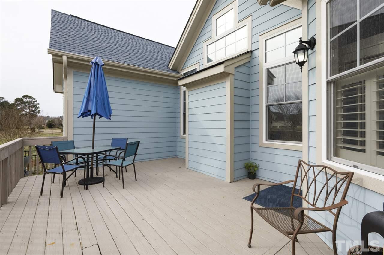 4609 Swordfish Drive Raleigh, NC 27603 - Photo 23 of 30 a view of a patio with table and chairs and wooden floor