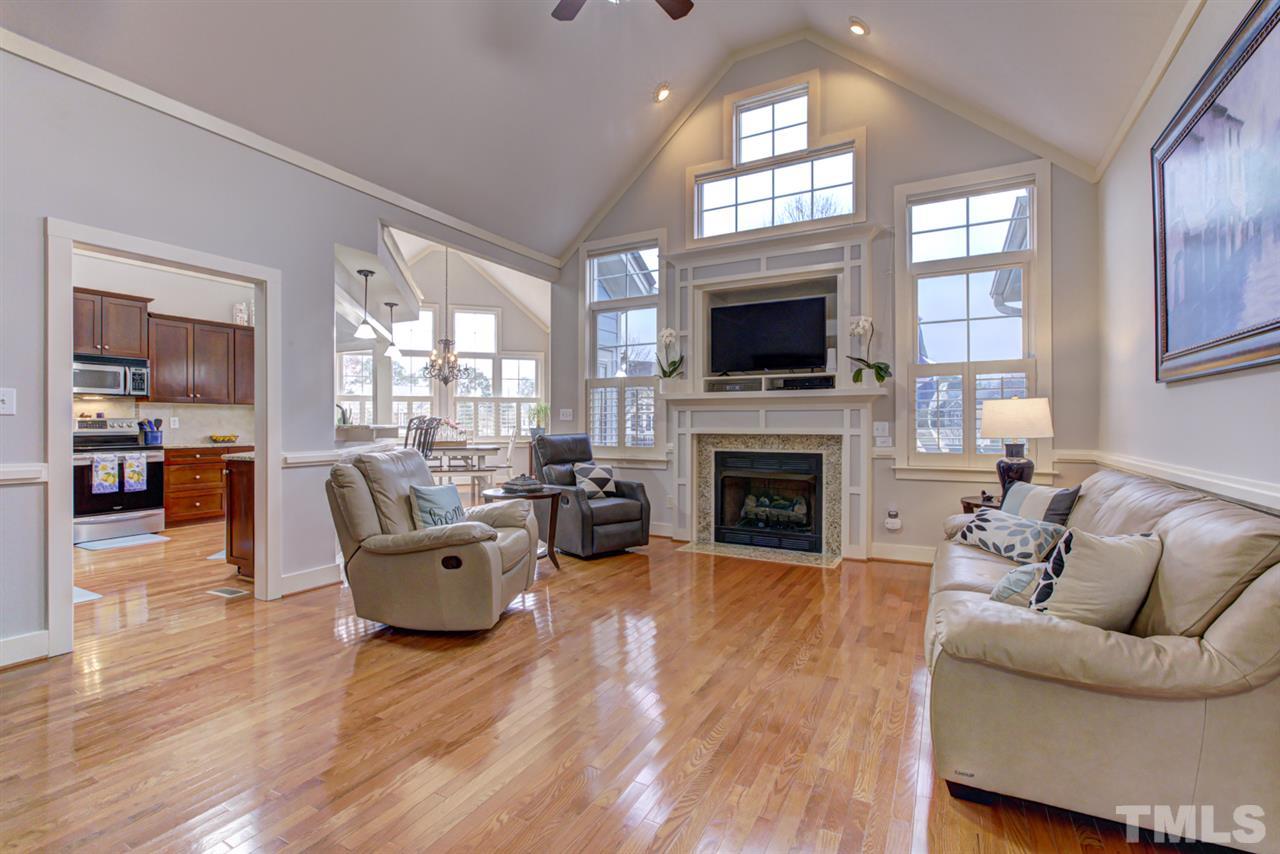 4609 Swordfish Drive Raleigh, NC 27603 - Photo 5 of 30 a living room with furniture a fireplace and a flat screen tv