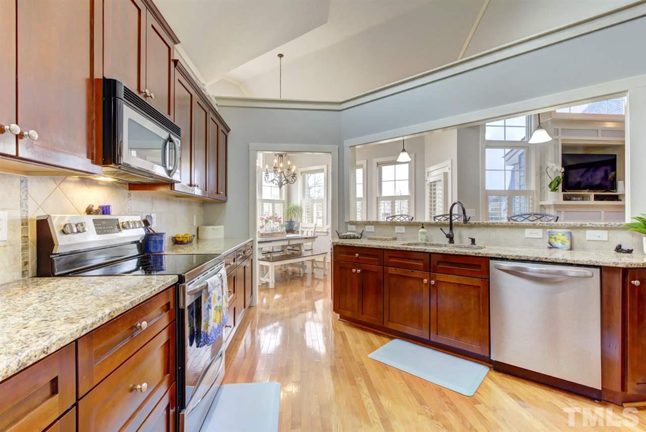 4609 Swordfish Drive Raleigh, NC 27603 - Photo 7 of 30 a large kitchen with stainless steel appliances granite countertop a lot of counter space and wooden floor