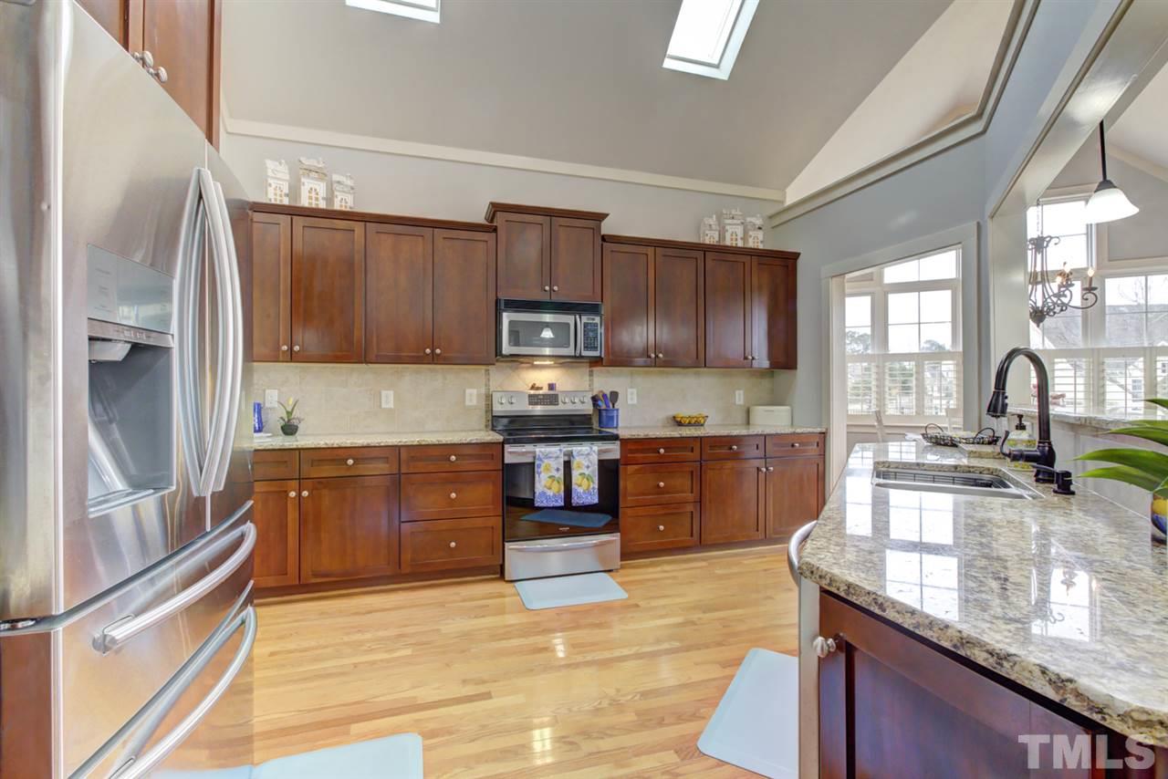 4609 Swordfish Drive Raleigh, NC 27603 - Photo 8 of 30 a kitchen with stainless steel appliances granite countertop a stove sink and cabinets
