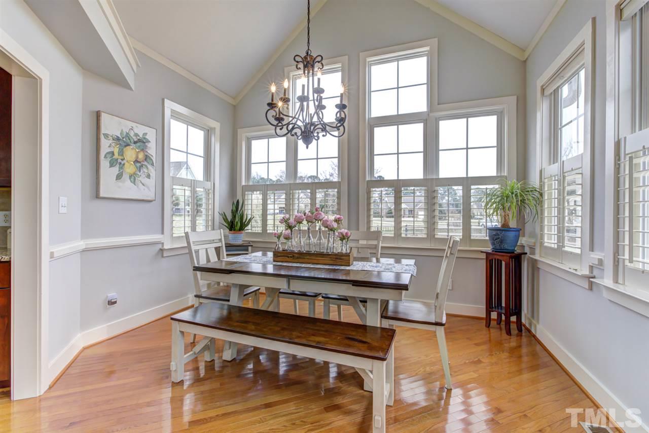 4609 Swordfish Drive Raleigh, NC 27603 - Photo 10 of 30 a view of a dining room with furniture a chandelier and wooden floor