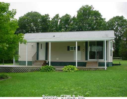 53 Hollowell Road Preston, CT 06365 - Photo 1 of 1 a front view of a house with a garden