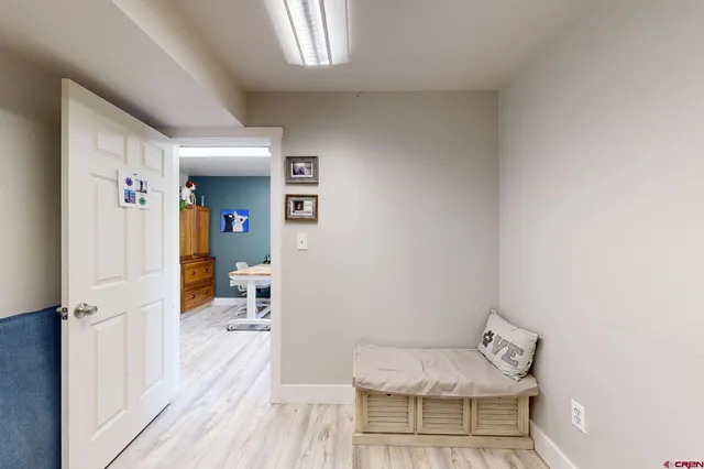 a view of a workspace with furniture and wooden floor