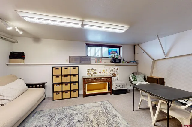 a hallway with white cabinets and wooden floor
