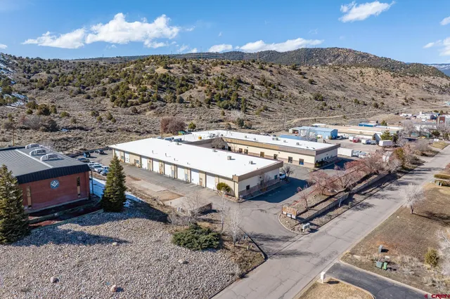 a view of a house with wooden fence