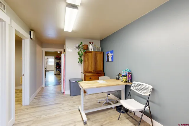 a dining room with furniture and window