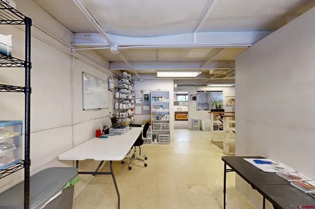 a room with a bed and a television