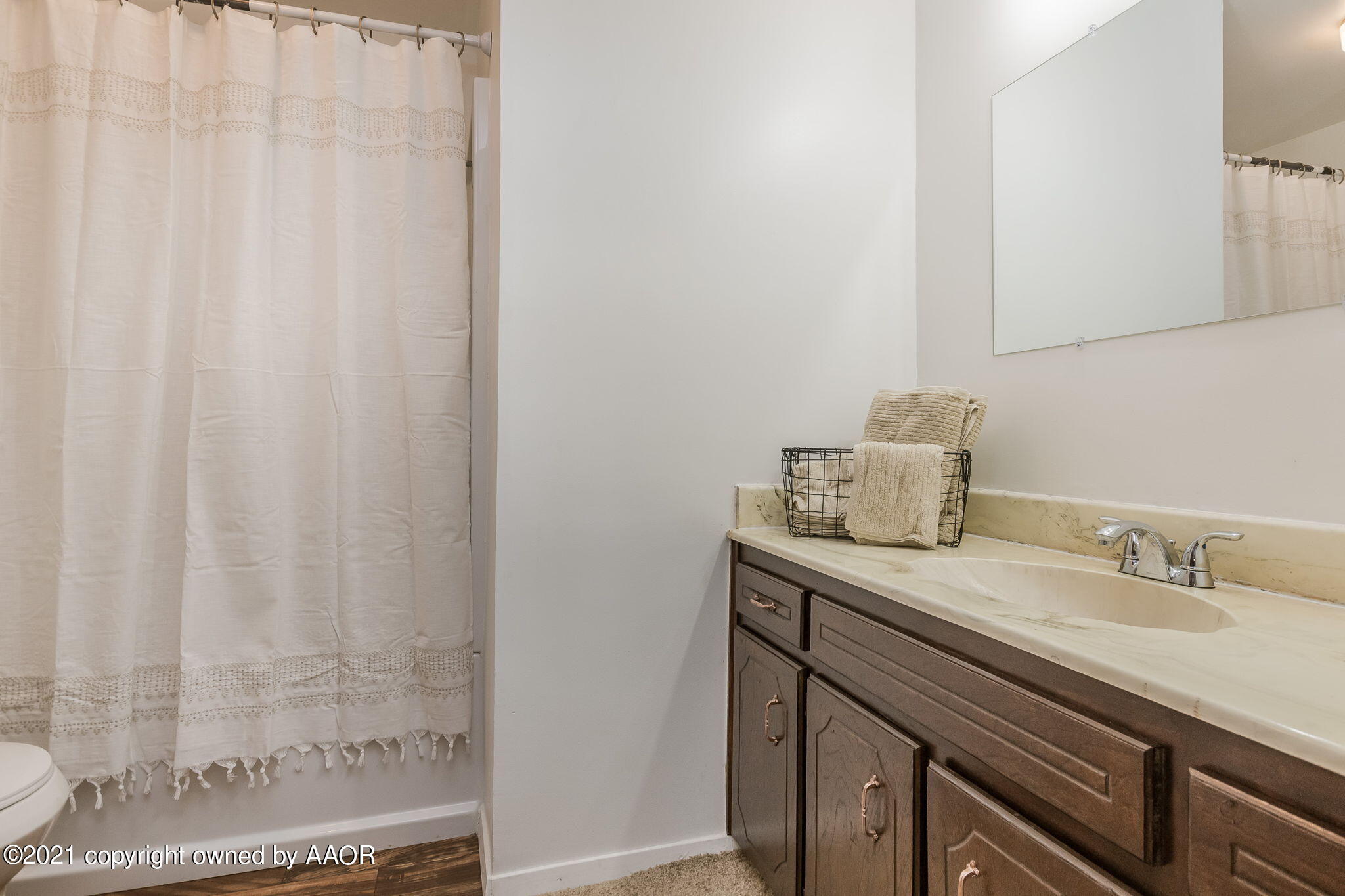 4914 South Georgia Street Amarillo, TX 79110 - Photo 13 of 19 a bathroom with a sink and a mirror