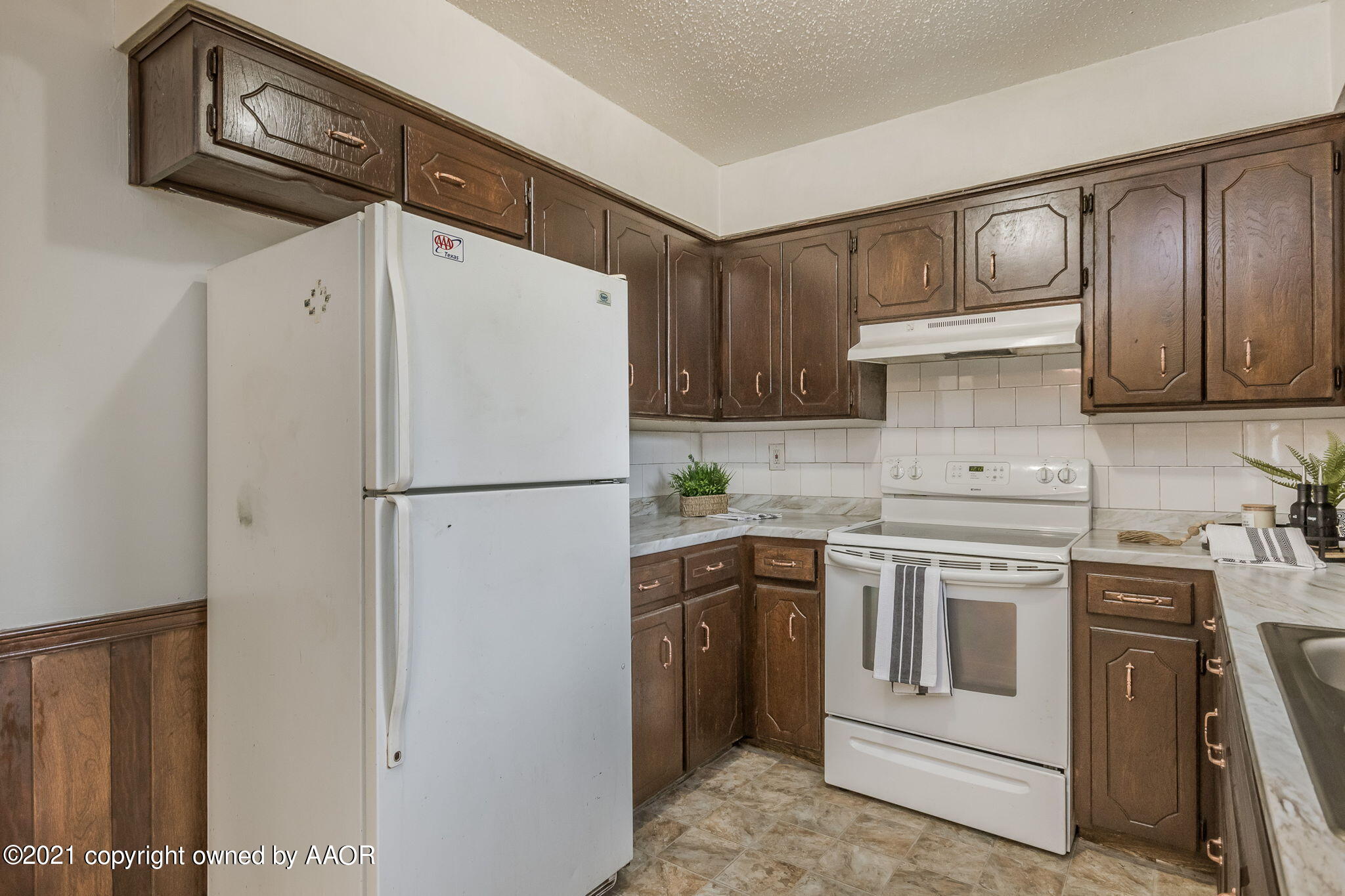 4914 South Georgia Street Amarillo, TX 79110 - Photo 16 of 19 a kitchen with a white cabinets and white appliances