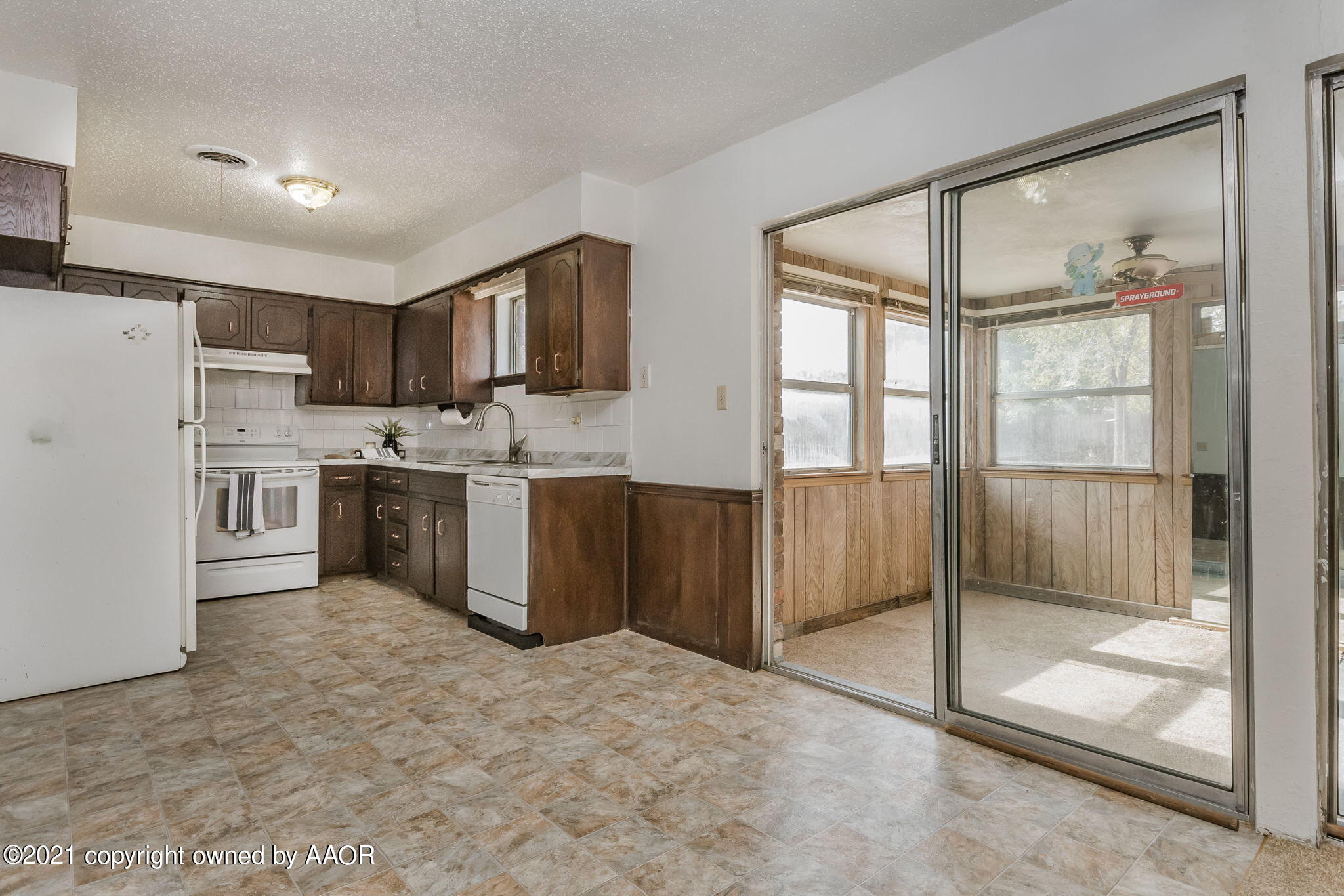 4914 South Georgia Street Amarillo, TX 79110 - Photo 4 of 19 a kitchen with stainless steel appliances granite countertop a refrigerator and a stove top oven