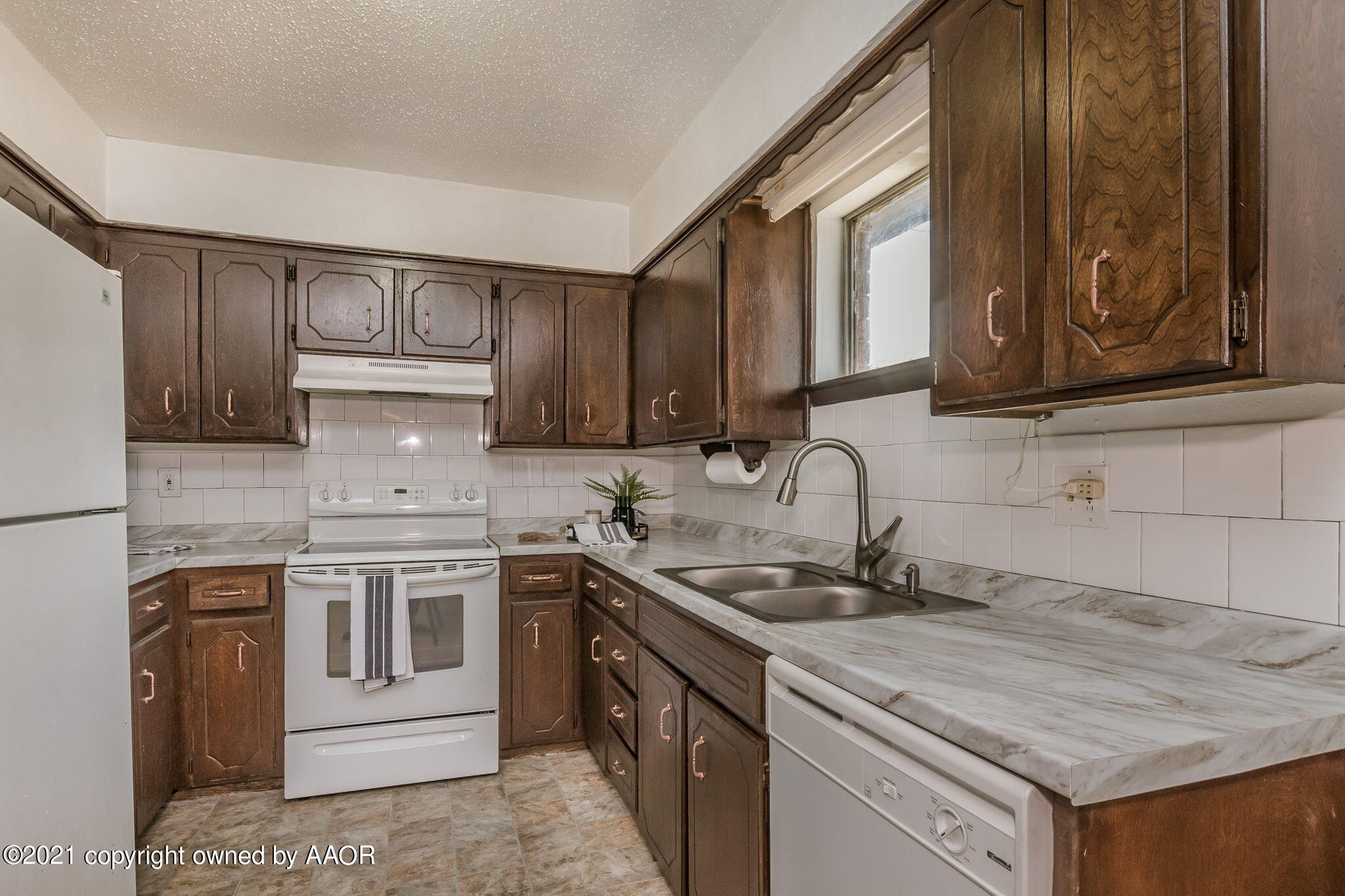 4914 South Georgia Street Amarillo, TX 79110 - Photo 10 of 19 a kitchen with stainless steel appliances granite countertop a sink stove and cabinets